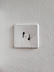Old Soviet-style wall radio socket with visible cracks in the plastic casing.