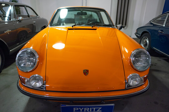 vintage Orange Porsche 911 T classic car, Oldtimer car retro-style, timeless automotive passion, history automotive industry, pop culture nostalgia, Frankfurt, Germany - December 16, 2023