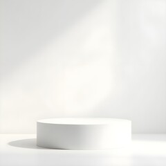 Fototapeta premium Minimalist white cylindrical podium on a clean studio background with natural window light and soft shadows for product presentation.