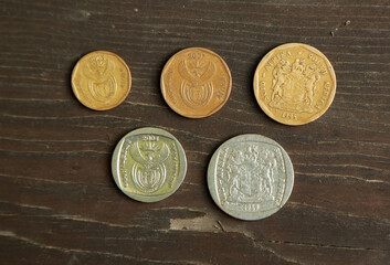 Coins of South Africa on wooden table