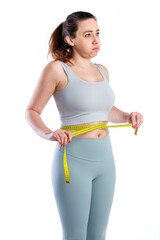 Woman checking waist measurement with tape