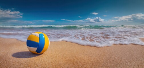 Obraz premium The vibrant volleyball resting on the sandy beach by the serene ocean waves.