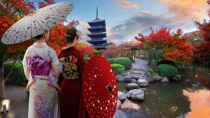 Japanese Woman in Traditional Kimono Dress at Toji Temple in Kyoto, Japan with beautiful garden and autumn foliage