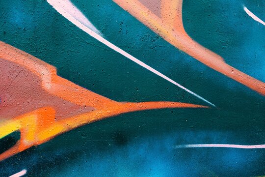 Abstract graffiti art with bold orange, teal, pink lines. Urban 90s style, trippy wave, vibrant colors. Backdrops, street posters, urban design, energetic digital art.