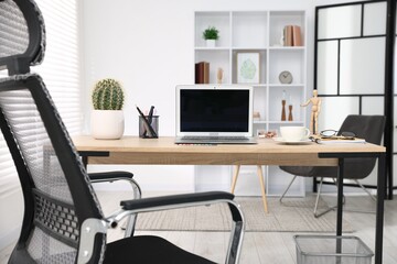 Stylish workplace with modern laptop on wooden desk