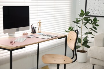 Stylish workplace with wooden desk, stationery and computer at home office. Interior design