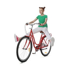 Naklejka premium Teenage girl riding bicycle on white background
