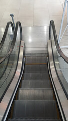 Empty escalator going down in a modern shopping mall