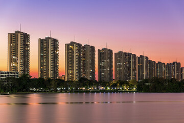 Landscape building modern business district of bangkok at twilgiht sky, beautiful water reflection.