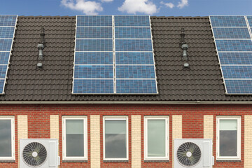 Row of new Dutch houses with solar panels and air-source heat pumps