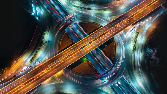 Expressway top view, Road traffic an important infrastructure, car traffic transportation above intersection road in city night, aerial view cityscape of advanced innovation, financial technology	