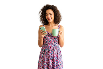 young woman holding phone and a cup isolated on white