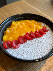 Chia seeds with coconut milk and fresh berries breakfast bowl. UGC cafe picture with healthy meal, close up no people 