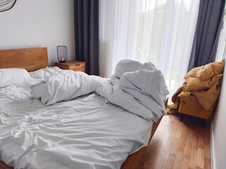 Cozy Bedroom with Unmade Bed and Natural Light