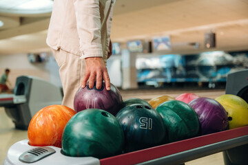 Fototapeta premium Taking the ball. Close up view of man that is playing bowling