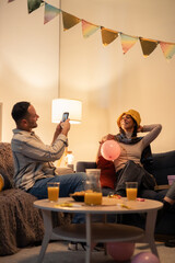 Friends enjoying birthday party, taking photos and having fun