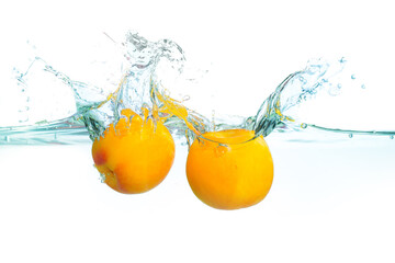 Fresh Apricots Splashing Into Clear Water Creating Dynamic Ripples