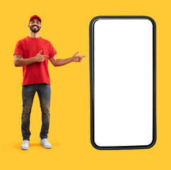 Arab Delivery Guy Showing Huge Phone Screen Pointing Fingers At Big Cellphone Advertising Online...
