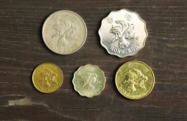 Coins from Hong Kong on a wooden table