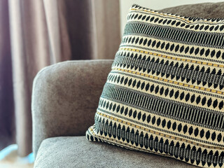 Decorative pillow resting on cozy sofa, enhancing home interior with stylish design and comfortable...