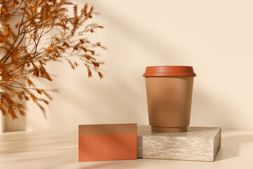 Autumn coffee cup with a gift card and fall leaves decoration on beige background. 3D rendering