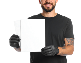 Man in black shirt and black gloves holding blank white papers against a solid white background; smiling; mid-section view; studio shot; isolated background