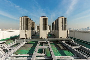 Exhaust vents of industrial air conditioning and ventilation units. Skyscraper roof top from high...