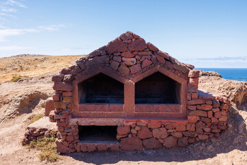 Large stone barbecue oven on the viewpoint of the east coast of Ponta de Sao Lourenco. Atlantic...