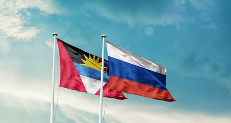 Antigua and Barbuda and Russia friendship flags are waving in the sky. Double country Flag waving with mast. Antigua and Barbuda Russia national flag for agreement.