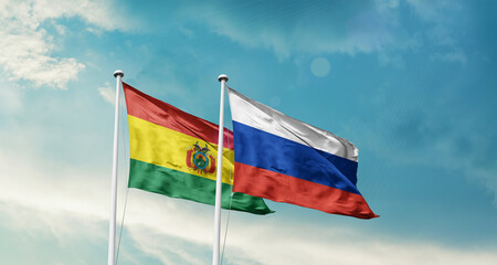 Bolivia and Russia friendship flags are waving in the sky. Double country Flag waving with mast. Bolivia Russia national flag for agreement.