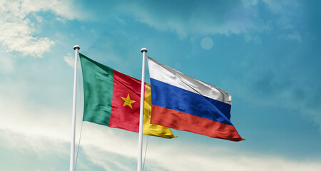 Cameroon and Russia friendship flags are waving in the sky. Double country Flag waving with mast. Cameroon Russia national flag for agreement.
