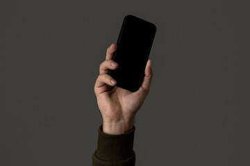 Close-up of Hand Holding a Smartphone with Blank Screen