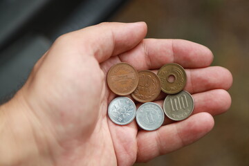 Japanese change coins in hand