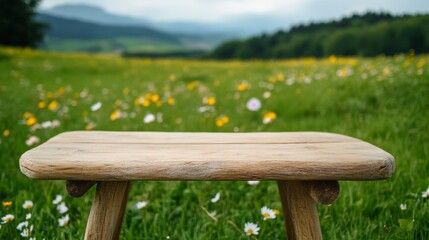 Fototapeta premium Rustic Wood Stool on Meadow with Blurred Mountains Backdrop, Nature, Scenery