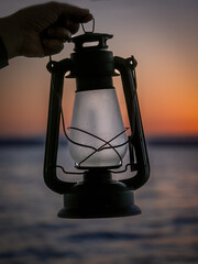 An old oil lamp backlit at sunset in the Albufera of Valencia (Spain)