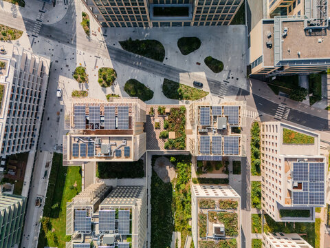 Aerial view of the The Paris 2024 Olympic and Paralympic Village with solar panels and green roofs casting shadows on the streets in Village des Athl&Atilde;&uml;tes Olympiques, &Atilde;Žle-de-France, France.