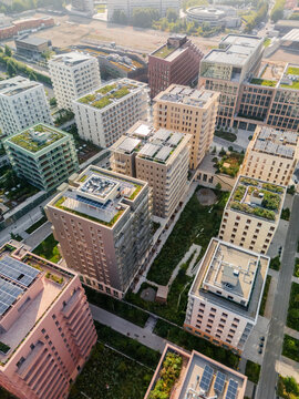 Aerial view of modern buildings with green roofs casting shadows on manicured lawns, 101 Boulevard Victor Hugo, Village des Athl&Atilde;&uml;tes Olympiques, &Atilde;Žle-de-France, France.