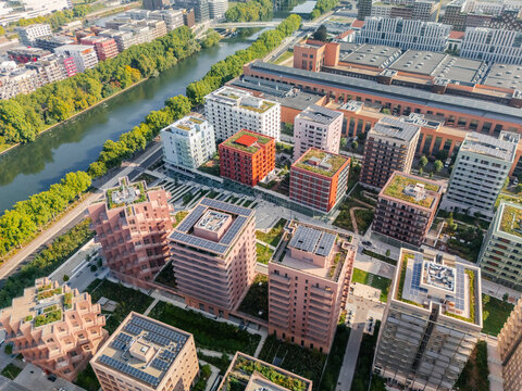Aerial view of the The Paris 2024 Olympic and Paralympic Village, where modern architecture meets lush greenery along the Seine, Saint-Ouen-sur-Seine, Azle-de-France, France.