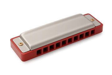 Metal-trimmed red harmonica resting on clear surface, capturing blues and folk music instrument essence