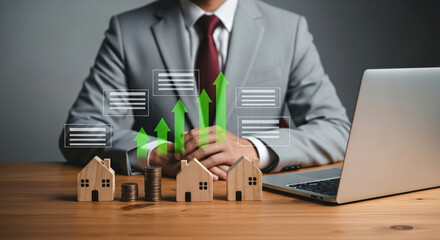 Businessman Planning Real Estate Investment with Growth Chart and Model Homes
