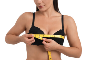 Woman in beautiful bra measuring breast circumference on white background, closeup