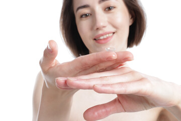 Woman with contact lens on white background, selective focus