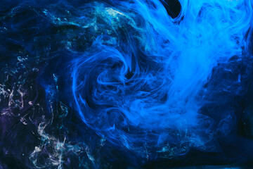 Abstract colorful smoke background. Moving flow of blue paints, fluid art