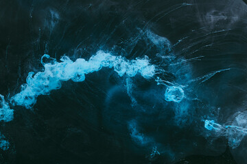 Abstract colorful smoke background. Moving flow of dark blue paints, fluid art