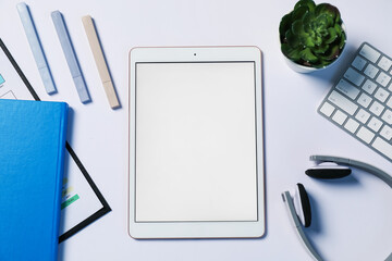 Tablet, different stationery, headphones, computer keyboard and floral decor on white background,...