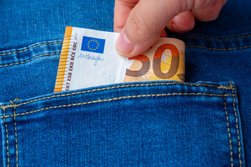 Hand thief pulling Euro banknotes, cash money from in pocket, pickpocketing scene, Pickpocket...