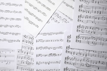 Fototapeta premium Sheets with musical notes as background, top view