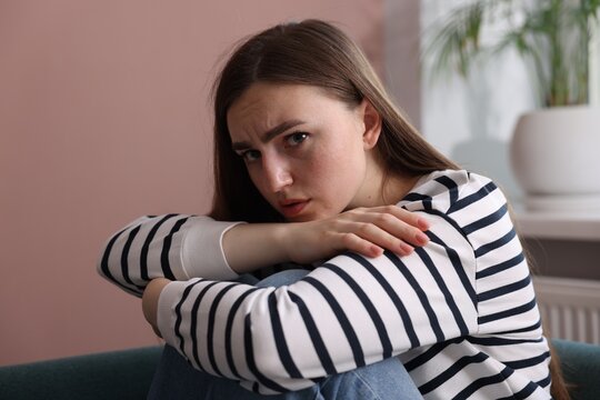 Worried woman suffering from paranoia at home