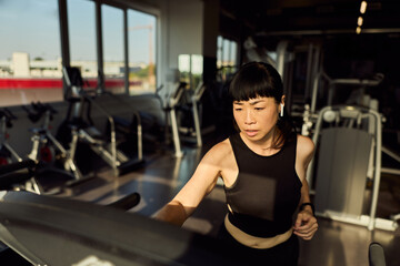 Focused Woman Exercising on Treadmill in Modern Fitness Gym