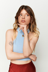 Young beautiful woman enjoying summer vibes with thoughtful pose in bright clothing